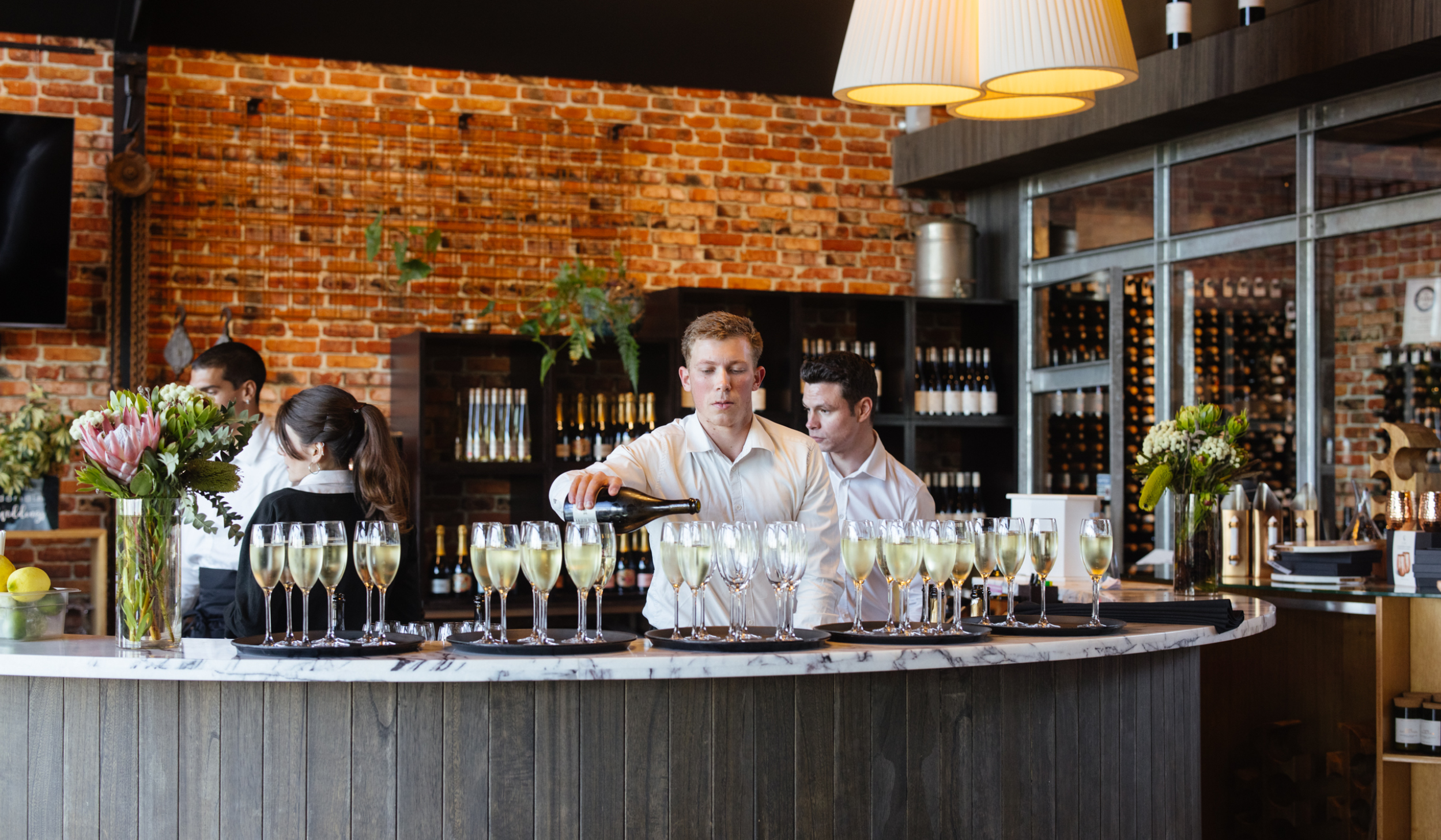 Man pouring wine in Wills Domain cellar door